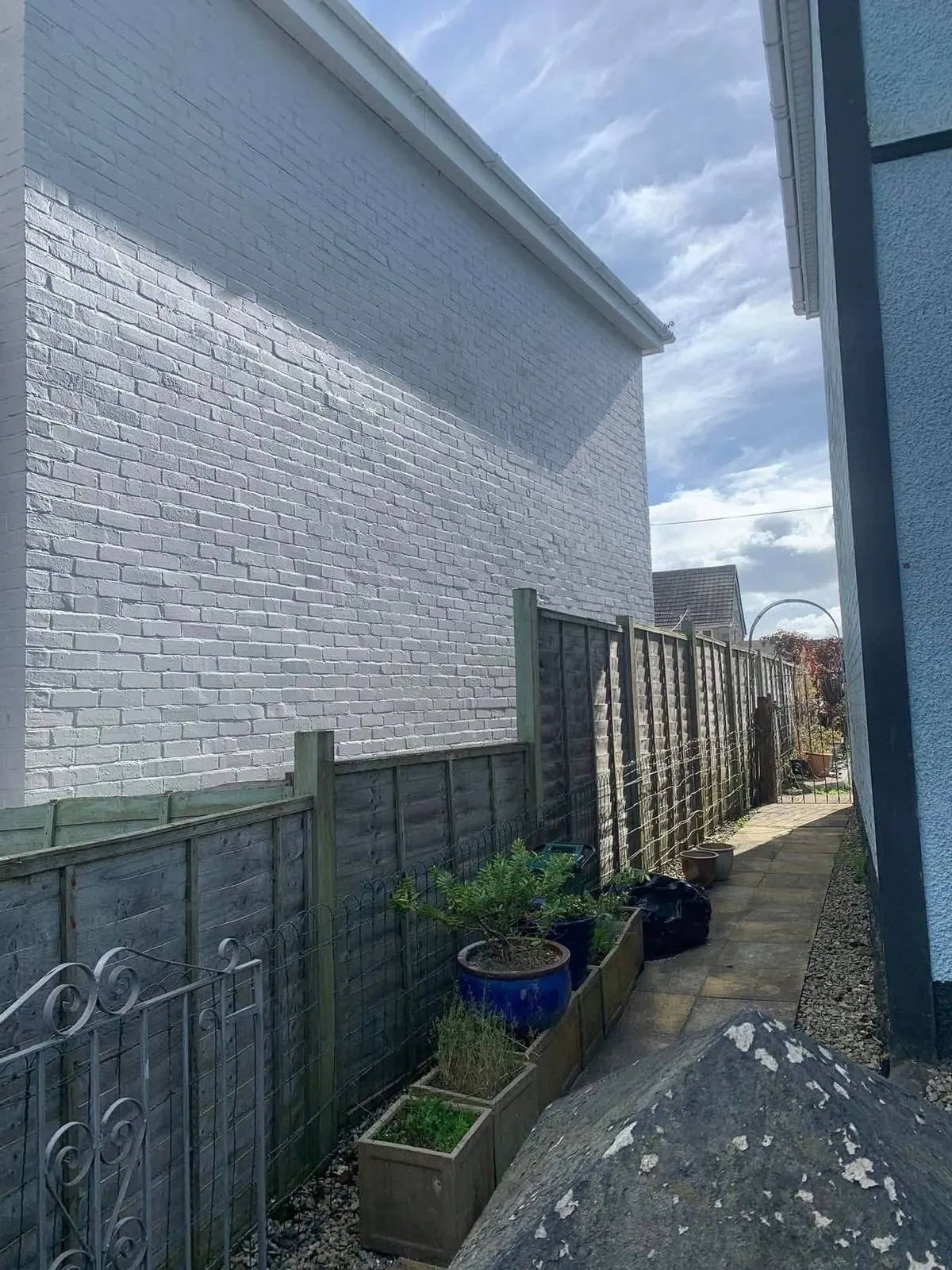Freshly painted brick wall after preparation and masonry paint in Lostwithiel